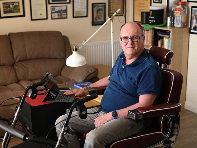 Citizen pictured in a wheelchair with laptop