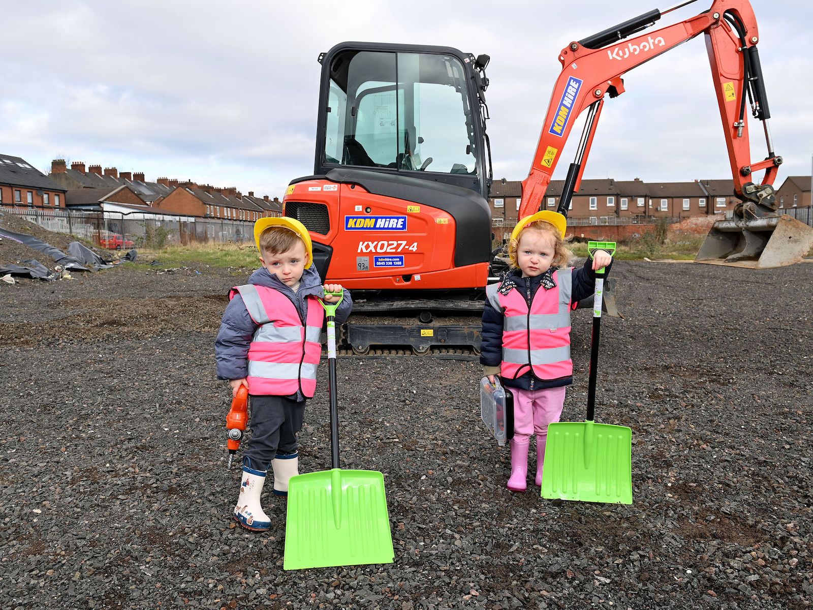 Two small children standing on the site where the new Shankill Shared Women’s centre will be built